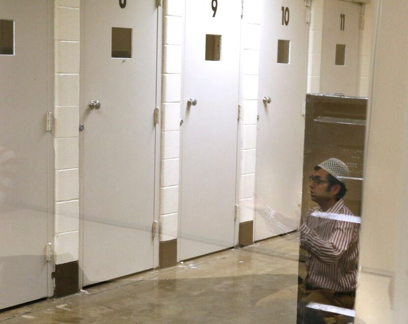  Mehmet Soyer, Raindrop Foundation Director/Dallas, is seen in a reflection as he prays...