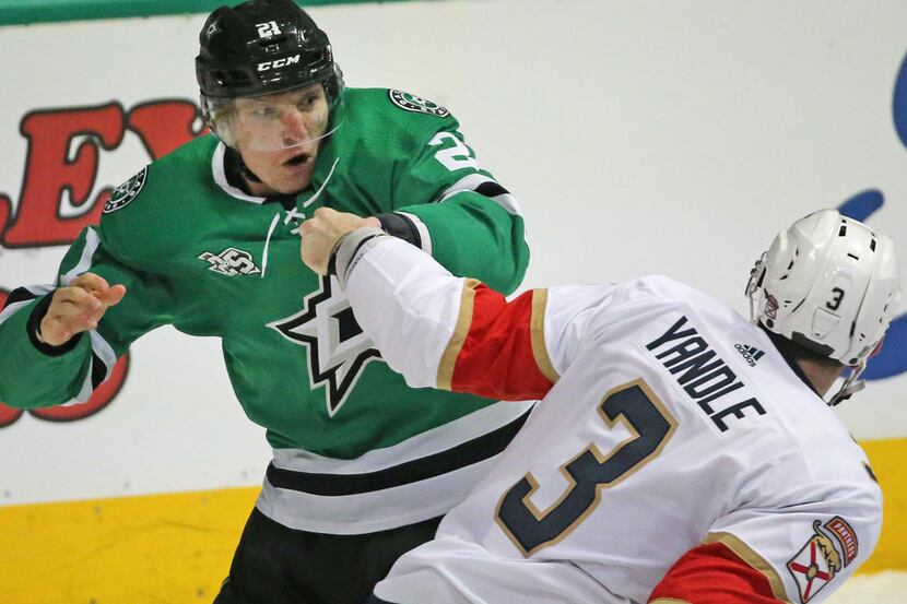 Dallas Stars left wing Antoine Roussel (21) and Florida Panthers defenseman Keith Yandle (3)...