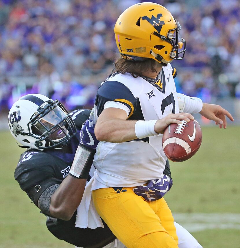 TCU defensive end Ben Banogu (15) pressures West Virginia quarterback Will Grier (7) in the...