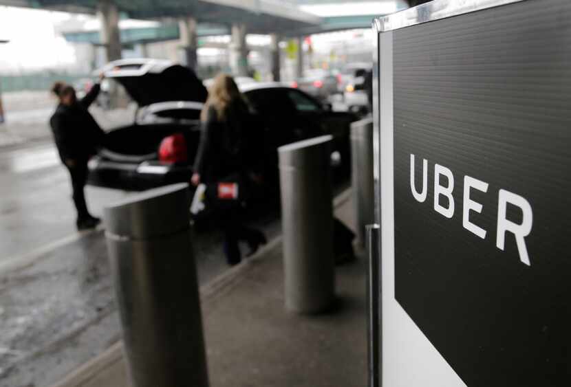 In this March 15, 2017, file photo, a sign marks a pick-up point for the Uber car service at...