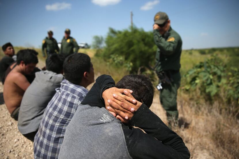  August 7: U.S. Border Patrol agents detain undocumented immigrants after they crossed the...