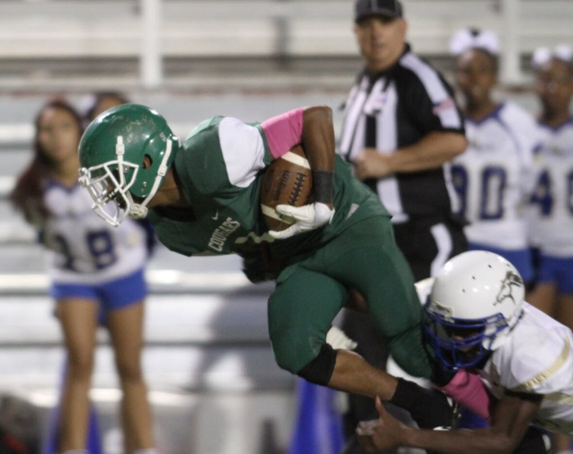 Bryan Adams receiver Nathan Stewart (1) lunges for extra yards as Conrad defensive back...