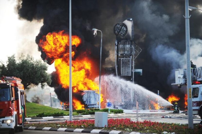 Israeli firefighters worked  to extinguish flames at a gasoline station in the Mediterranean...