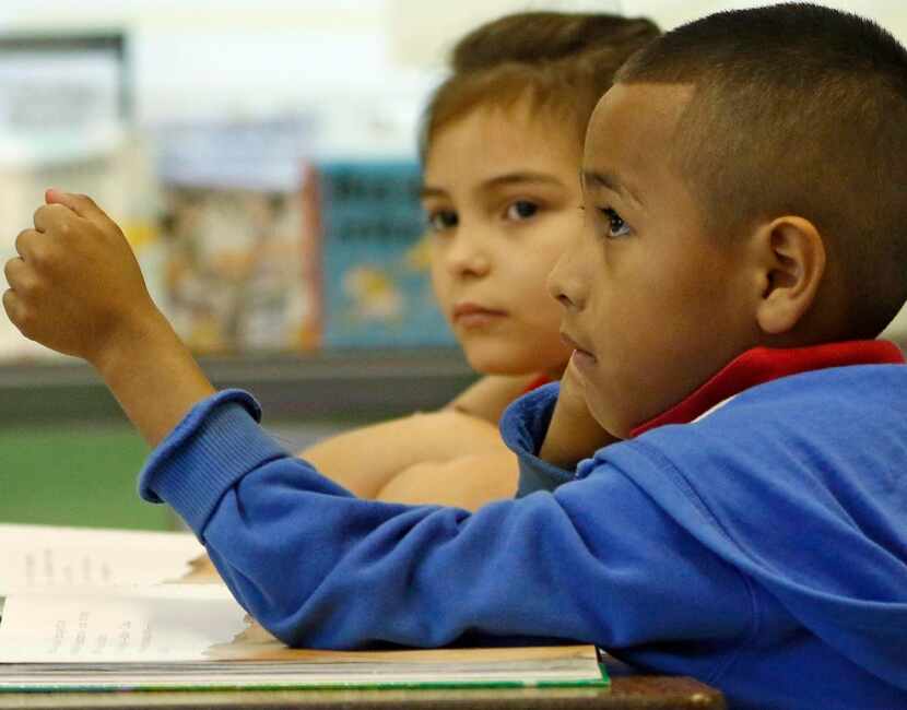 
First-grader Jonathan Vera Perez raises his hand during a two-way dual-language class at...