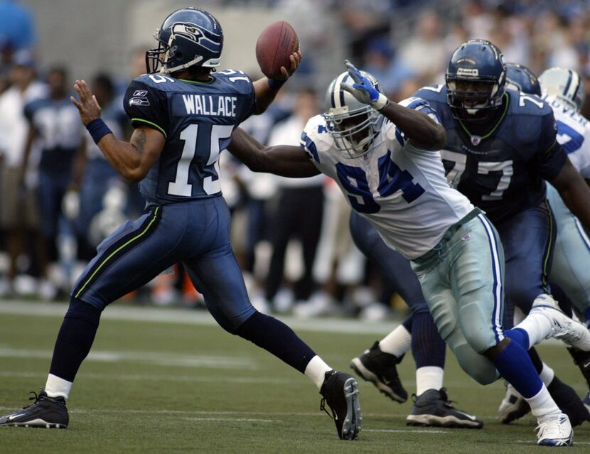 Dallas Cowboys Demarcus Ware (94) puts pressure on Seattle Seahawks quarterback Seneca...