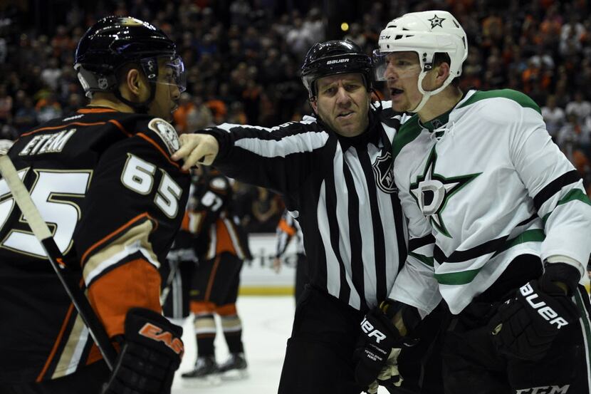 Apr 25, 2014; Anaheim, CA, USA; The referee tries to separate Anaheim Ducks left wing...