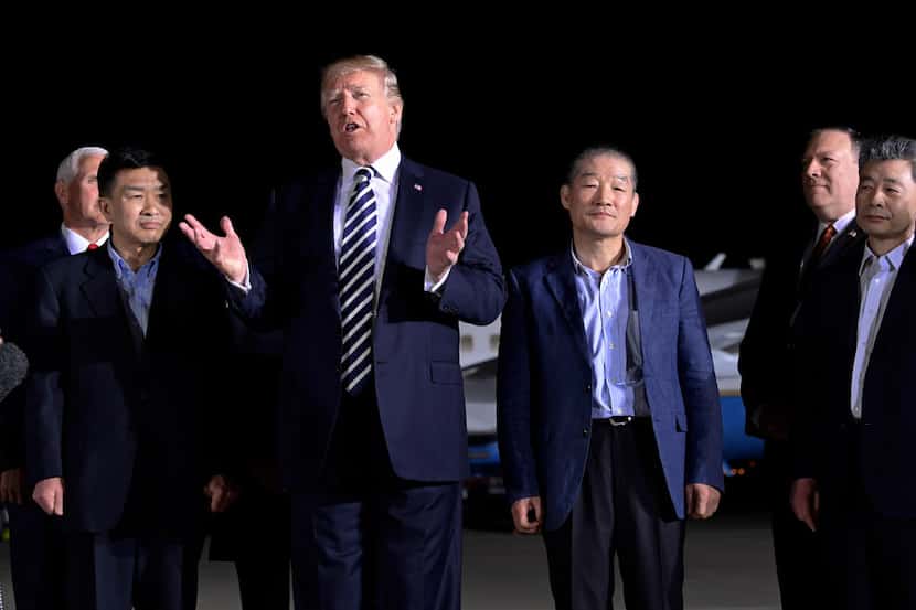 President Donald Trump speaks as he stands with Tony Kim (second from left), Kim Dong Chul...