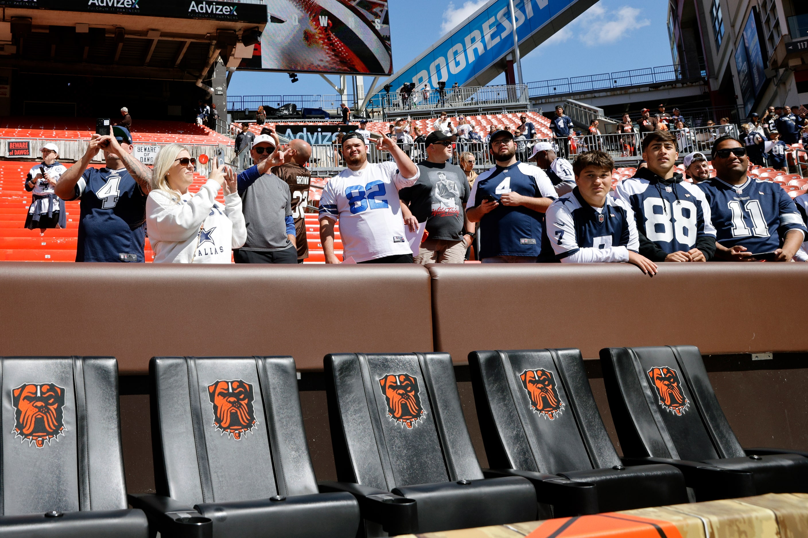 Dallas Cowboys fans watch player warm ups before the first half against the Cleveland...