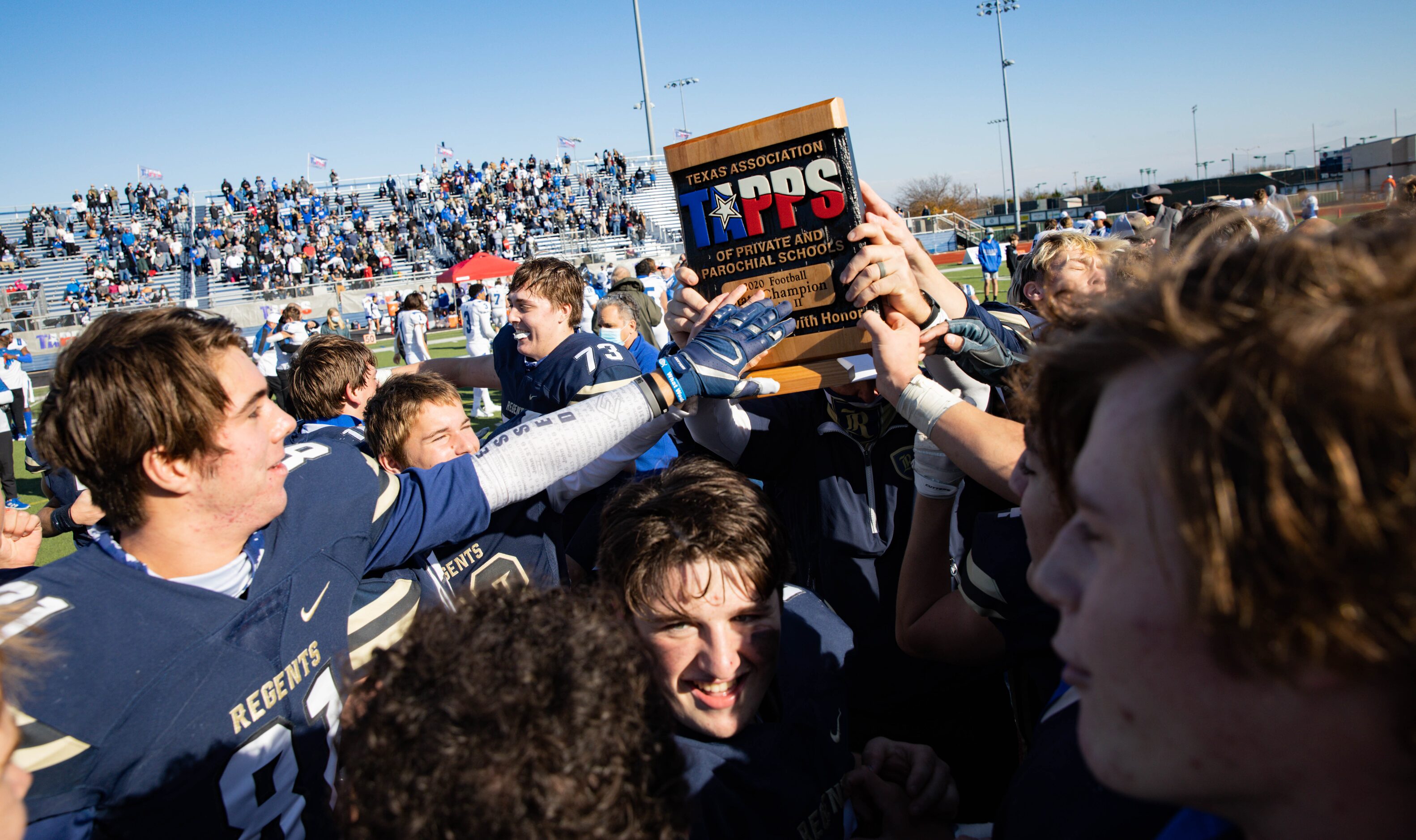 Austin Regents players celebrate after winning a TAPPS Division II state championship game...