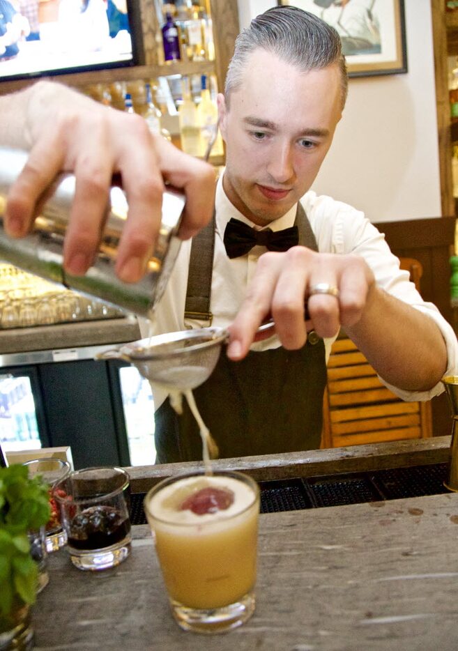 The Theodore Bar Manager Kyle Hilla prepares a "Badlands," Lemon, Woodford Reserve with a...