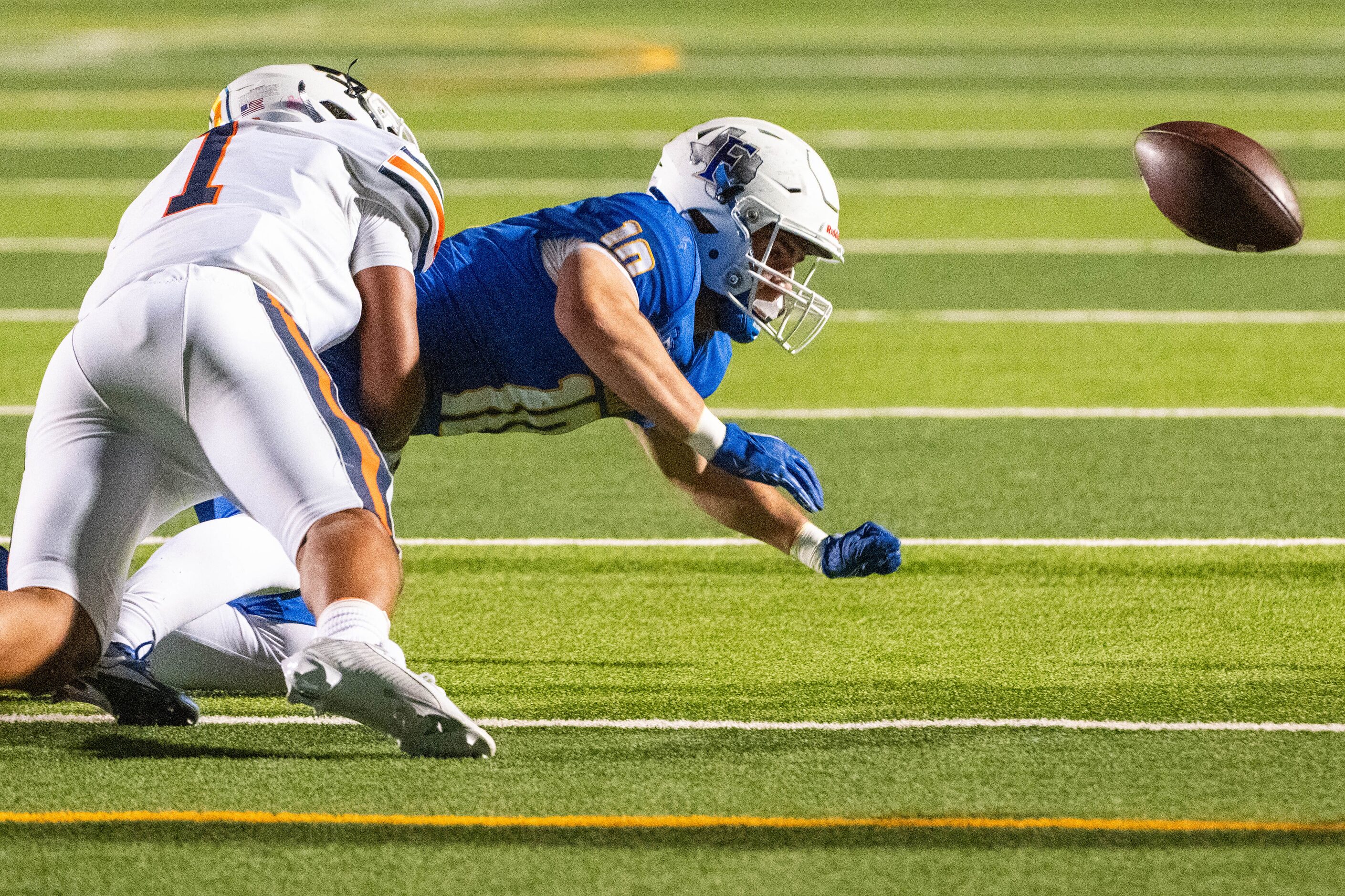 Frisco's Reed Engleman (10) can’t hold onto the pass after taking a hit from Wakeland's...