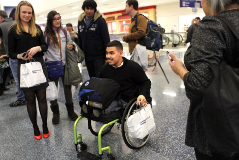 At DFW International Airport, Brian Monroy-Orozco and other amputee patients from Texas...