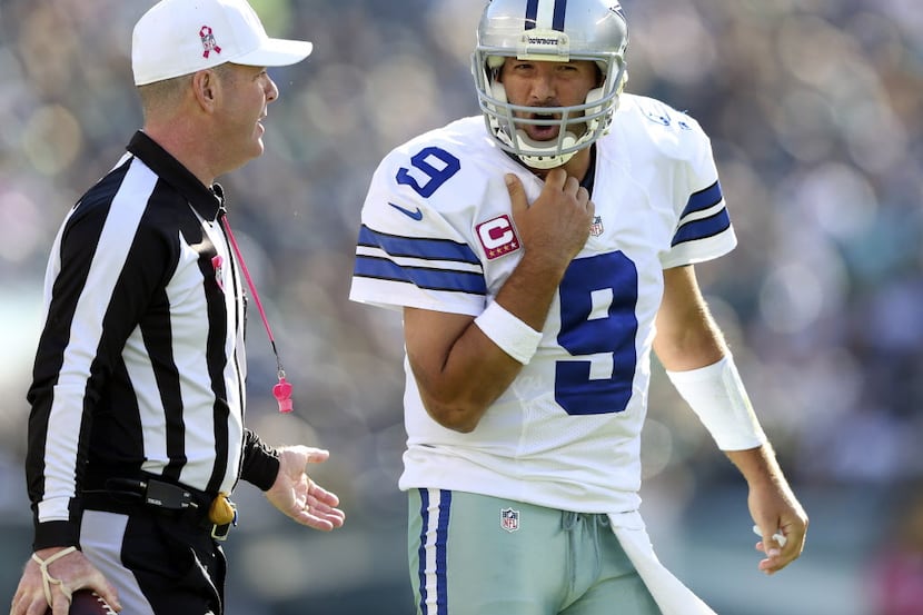 Dallas Cowboys quarterback Tony Romo (9) argues with referee John Parry (132) for not making...