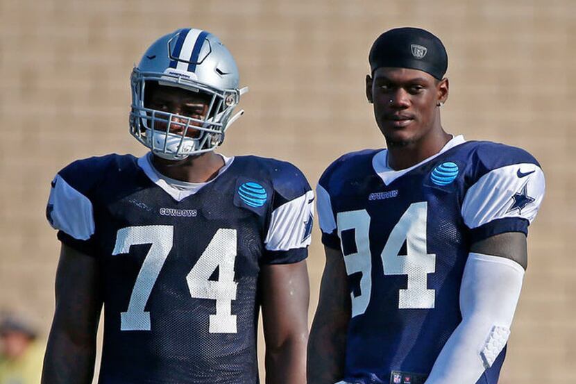 Cowboys defensive ends Dorance Armstrong (74) and Randy Gregory watch teammates go through a...
