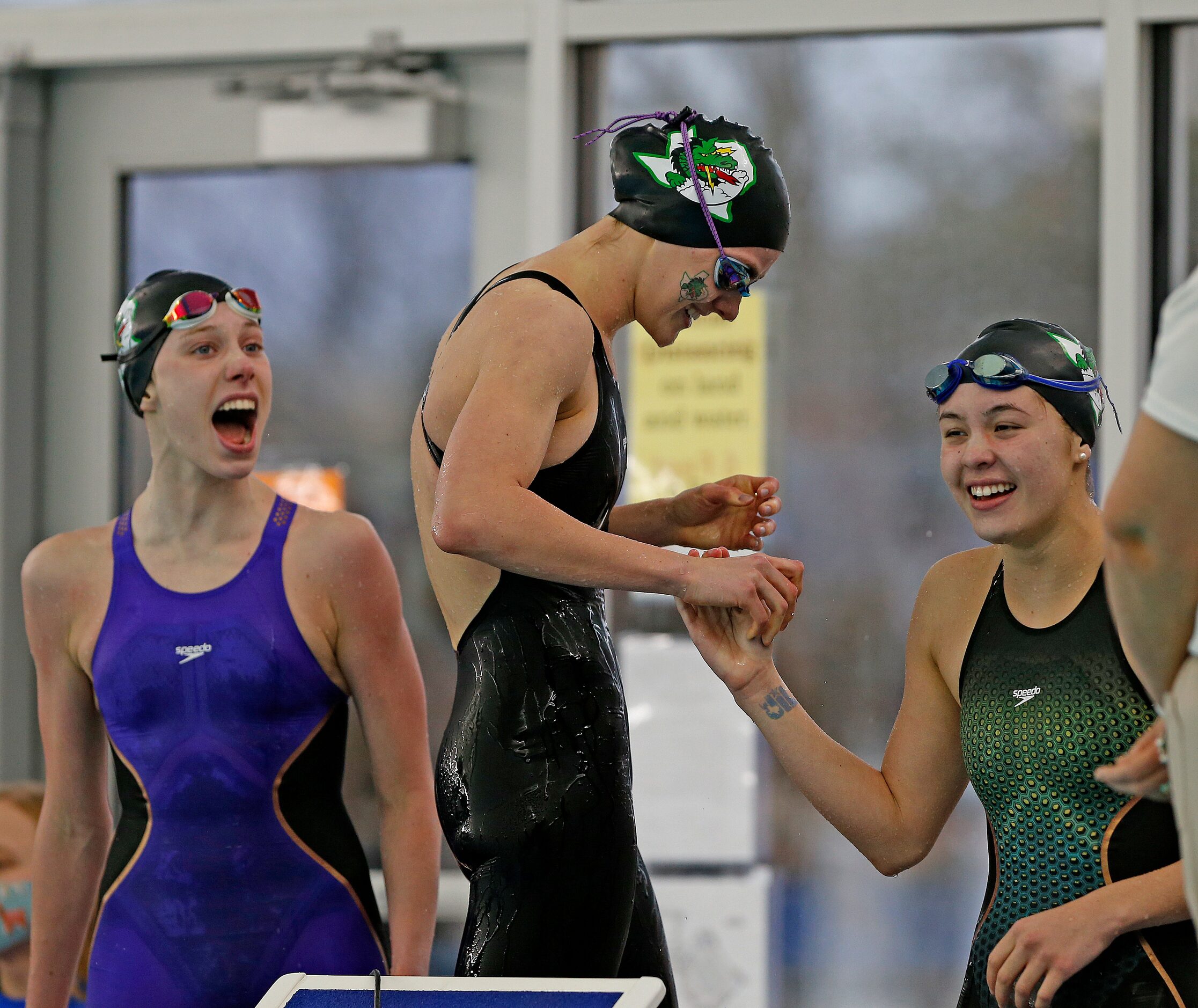 Southlake Carrol Hailey Hildenbrand,L,Morgan Chockholek, C is congratulated by Corbyn...