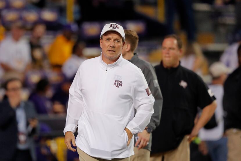 Texas A&M head coach Jimbo Fisher walks on the field before an NCAA college football game...