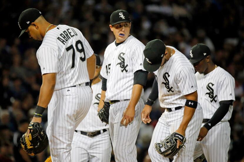 CHICAGO, IL - JULY 28: Derek Holland #45 of the Chicago White Sox (C) reacts after manager...