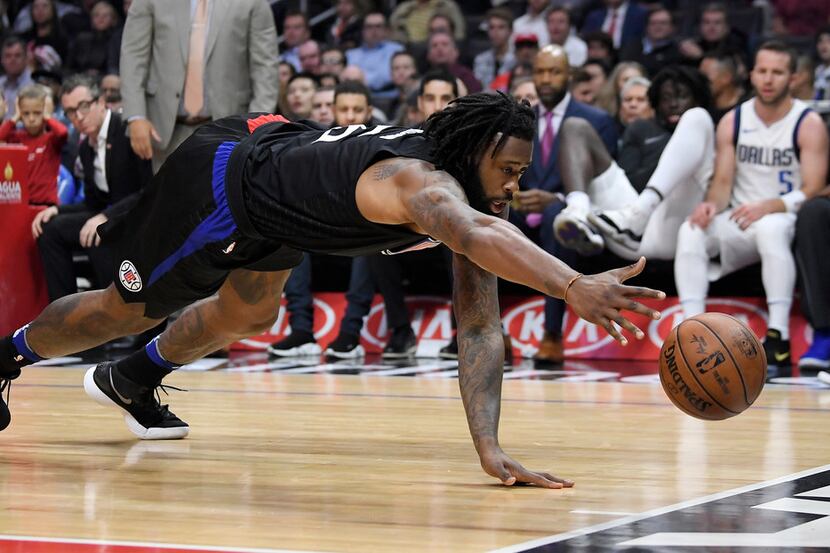 Los Angeles Clippers center DeAndre Jordan dives for a loose ball during the first half of...