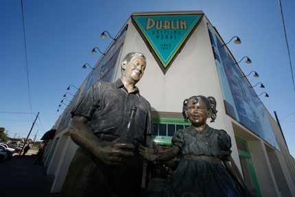 A statue of W. P. "Bill" Kloster handing a Dr Pepper to a girl, titled The Inspiration,...