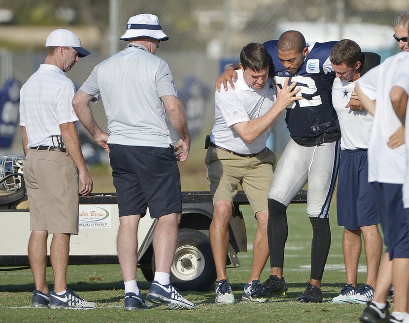 Dallas Cowboys cornerback Orlando Scandrick (32) is placed on a cart after injuring his knee...