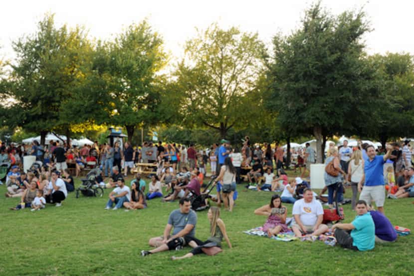 Friends and families enjoy music and beer at Oktoberfest in Addison Circle Park in Addison,...