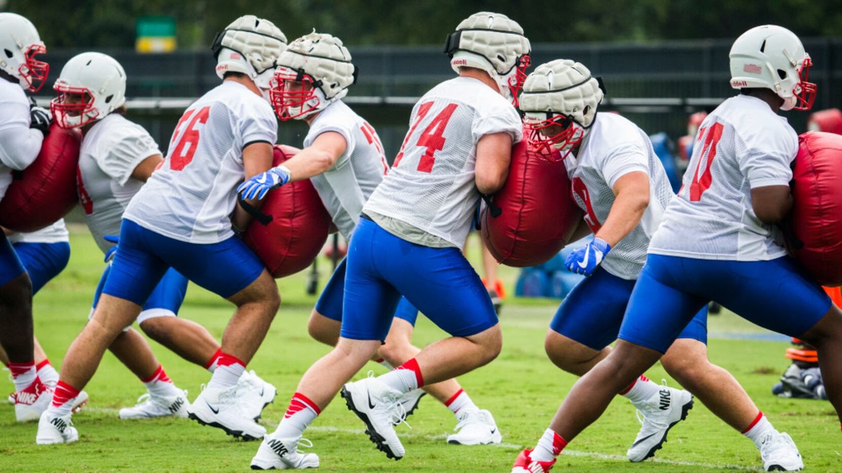 Football players work out during SMU's first football practice of the season on Tuesday,...