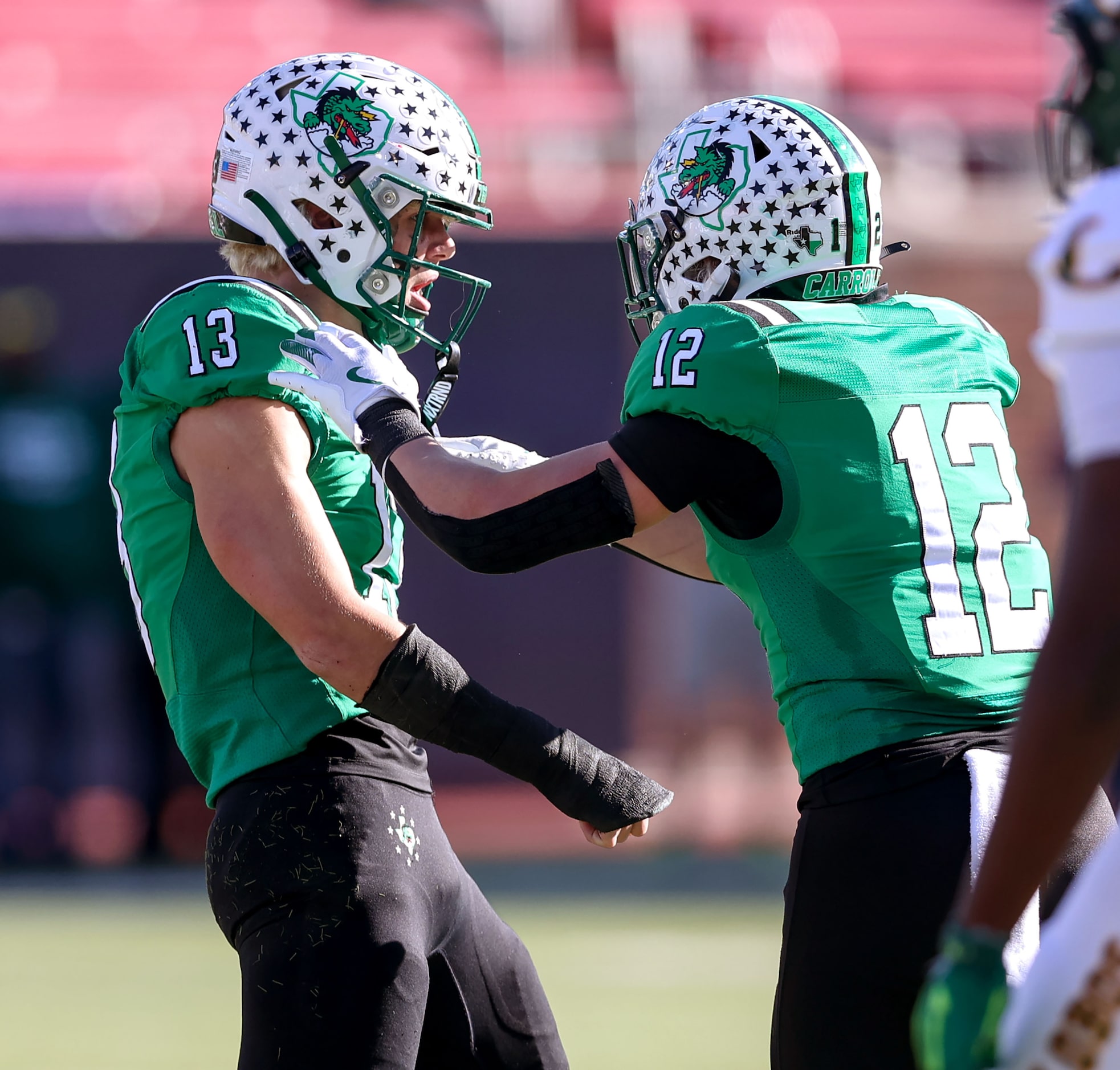 Southlake Carroll defensive lineman Zac Hays (13) celebrates with linebacker Marcus Brouse...