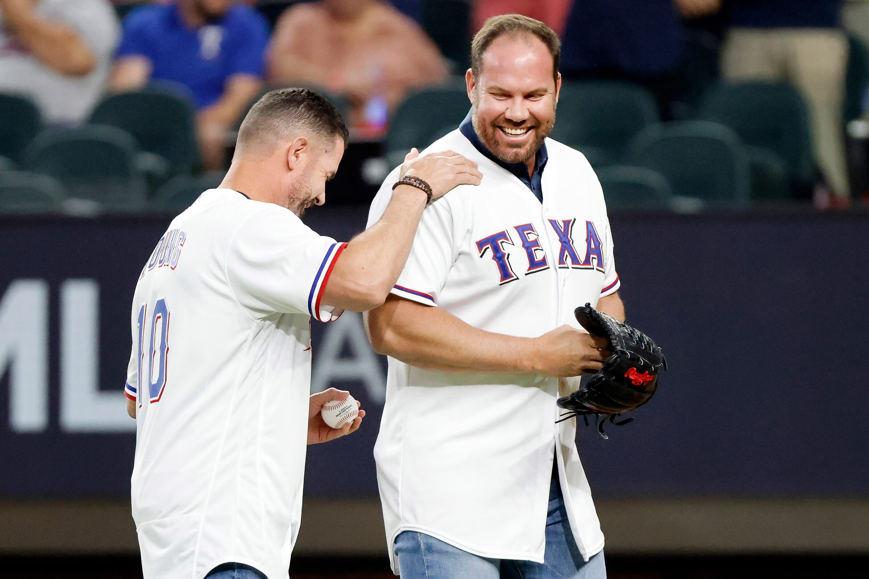 Former Texas Rangers infielder Michael Young (left) laugh after he threw out the ceremonial...