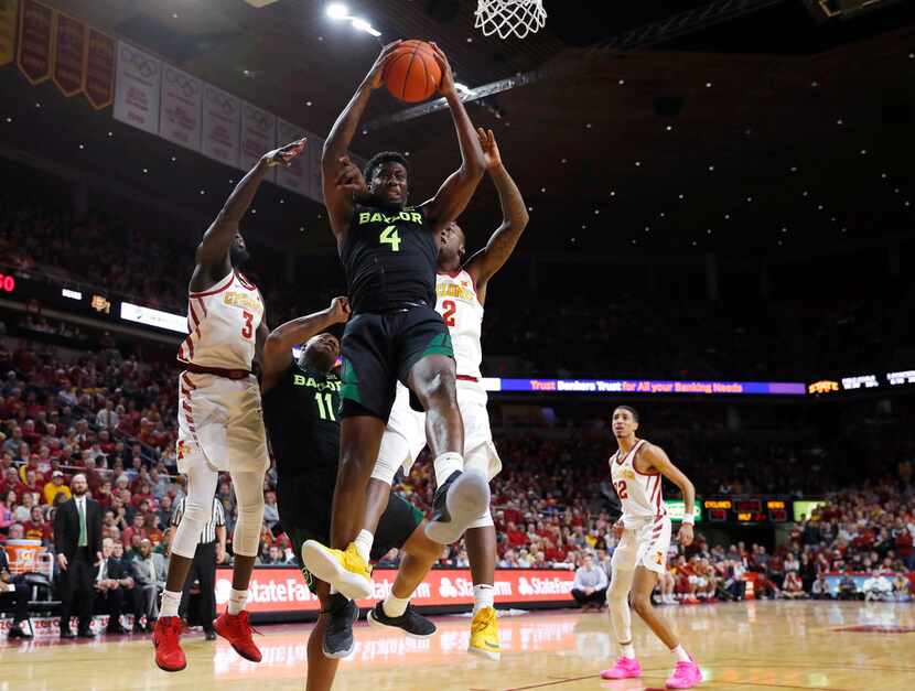 Baylor guard Mario Kegler, center, pulls down a rebound during the second half of the team's...