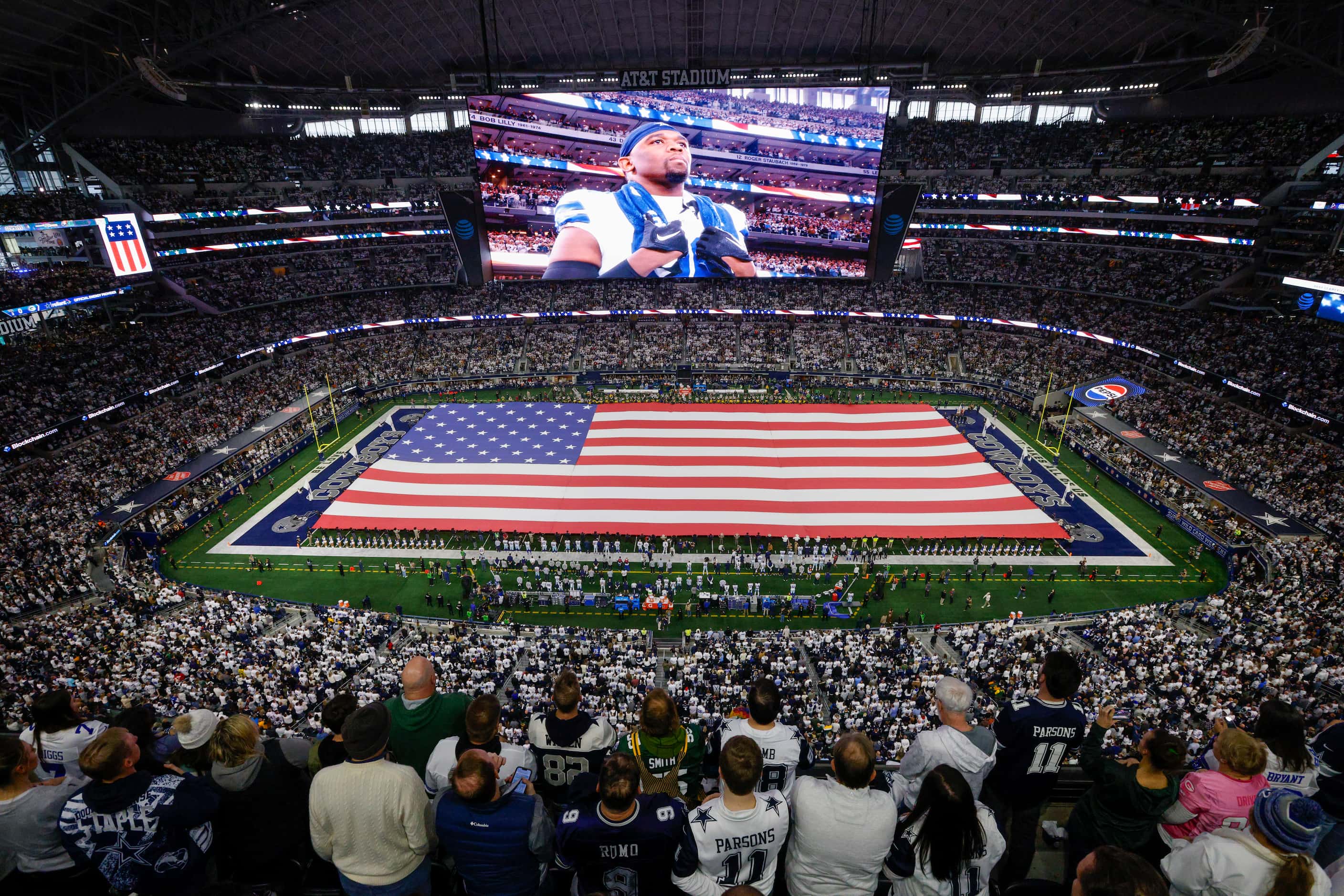 Fans stand for the national anthem before the first half of an NFL wild card playoff game...