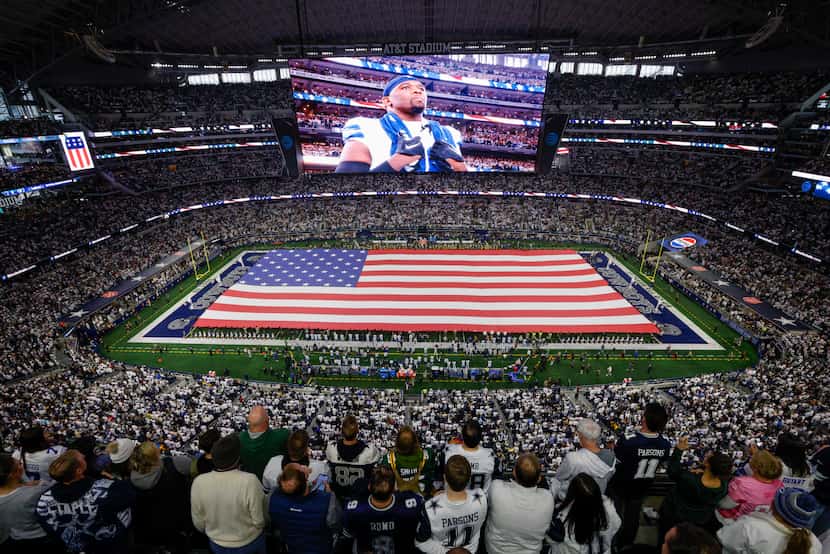 Fans stood for the national anthem before the first half of an NFL wild card playoff game...