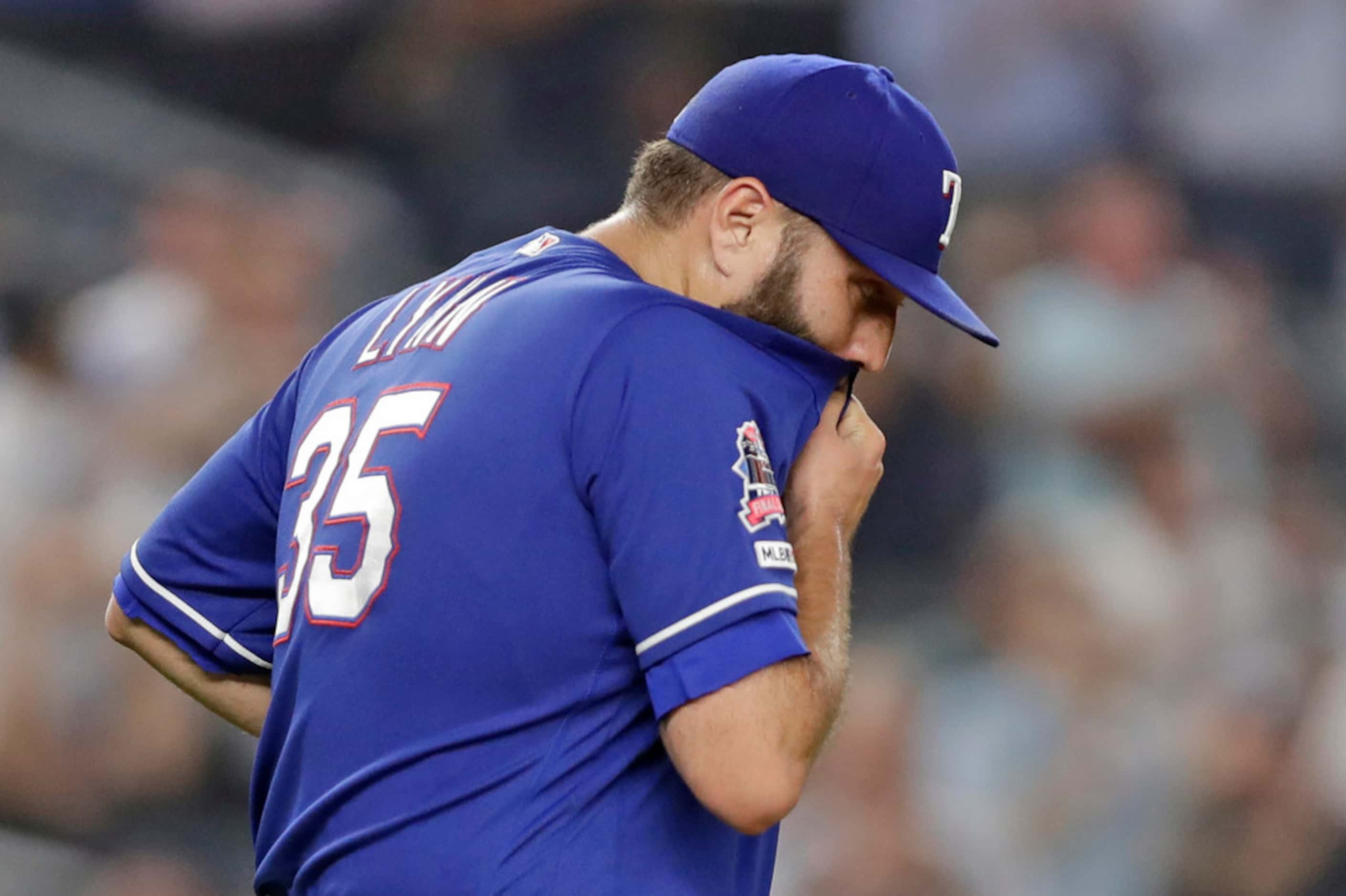 Texas Rangers starting pitcher Lance Lynn reacts after allowing a two-run home run to New...