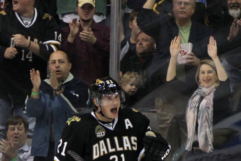 Dallas' Loui Eriksson (21) and fans behind the glass celebrate his first-period goal during...