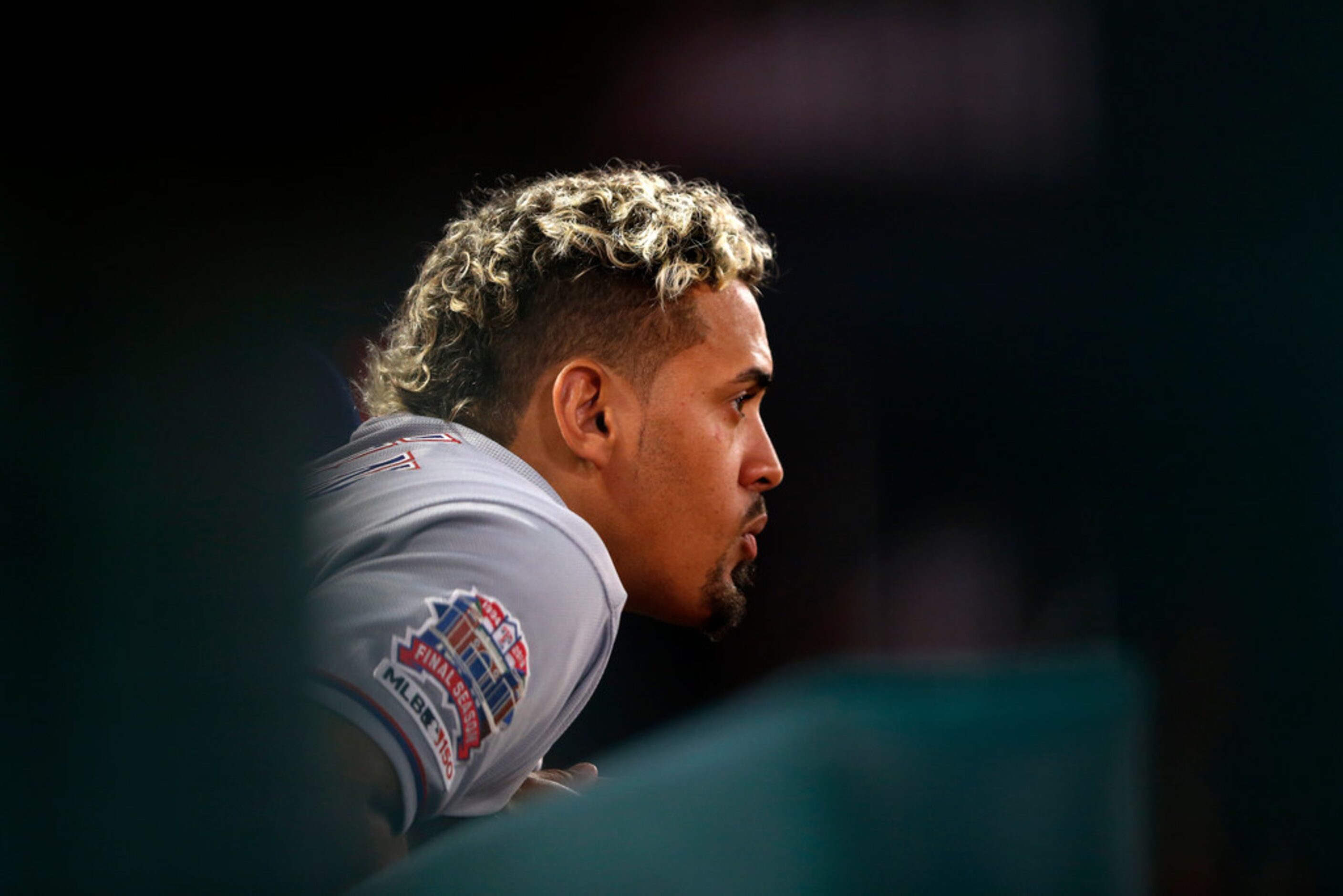 ANAHEIM, CALIFORNIA - MAY 24:  Ronald Guzman #11 of the Texas Rangers looks on from the...