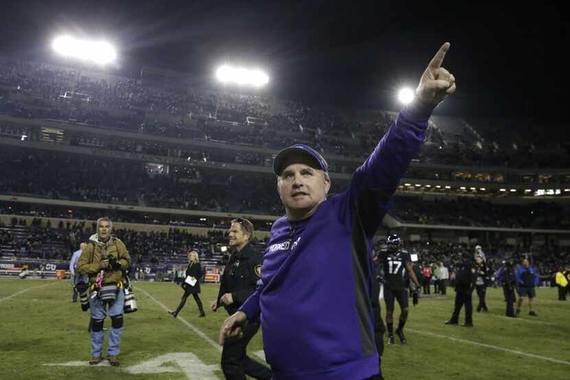 TCU head coach Gary Patterson points to fans as he runs off the field after an NCAA college...