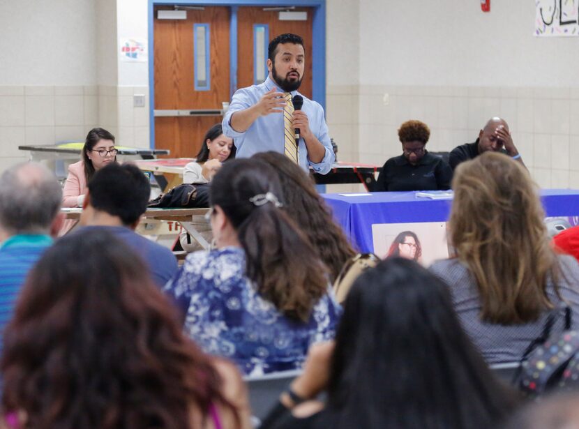 Ramiro Luna addresses a cafeteria full of immigrant parents in Mesquite on Tuesday. Issues...