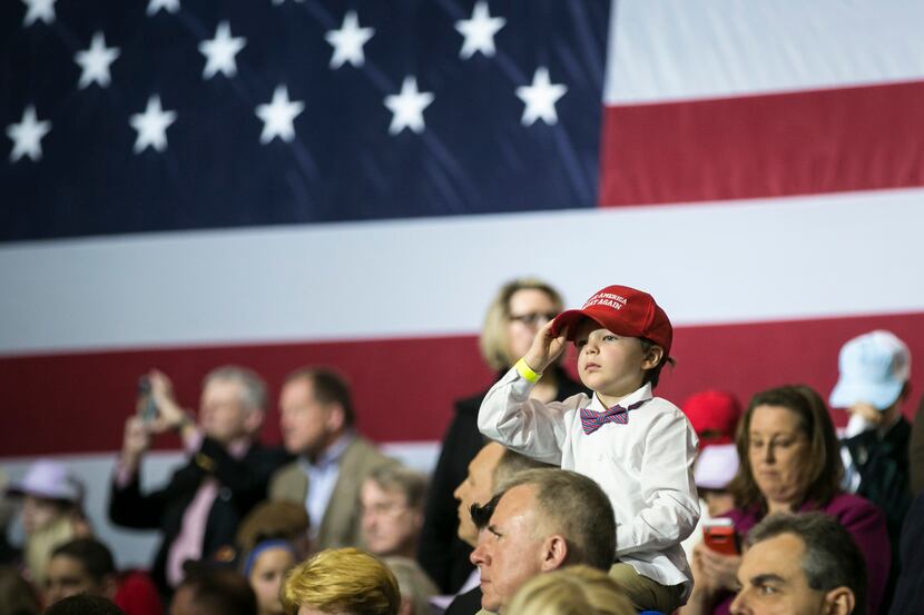A child wearing a Make America Great Again hat in a crowd waiting to hear President Donald...
