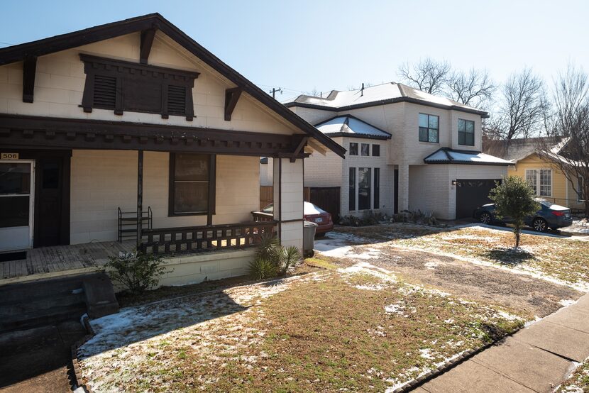 A historic style home, left, alongside a new modern style home, right, on South Willomet...