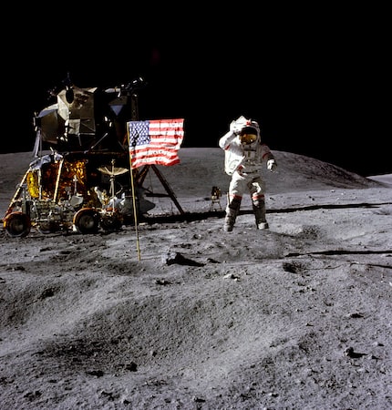 In this April 1972 photo made available by NASA, John Young salutes the U.S. flag at the...