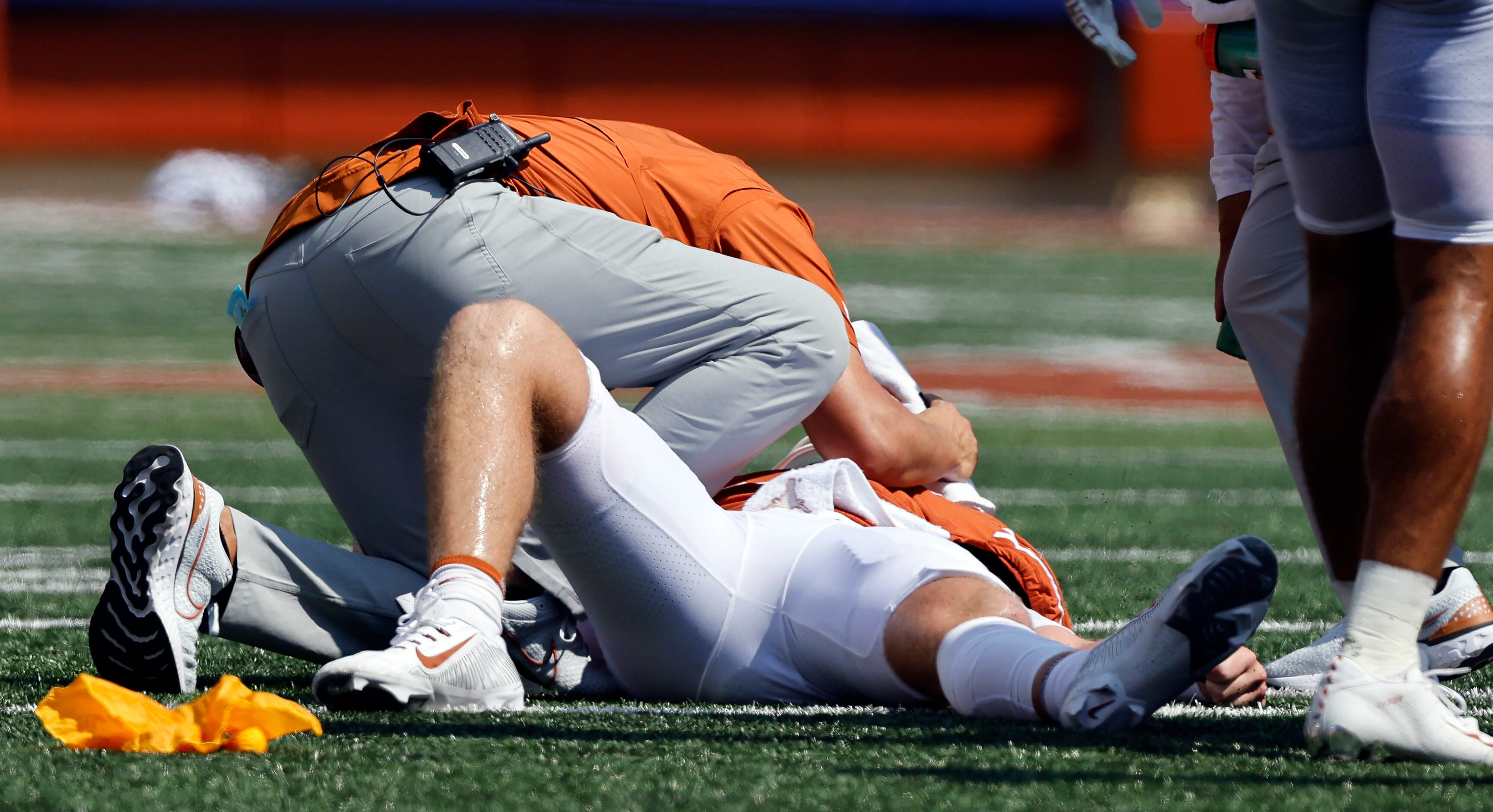 Texas Longhorns quarterback Quinn Ewers (3) is tended to after he took a hard hit from the...