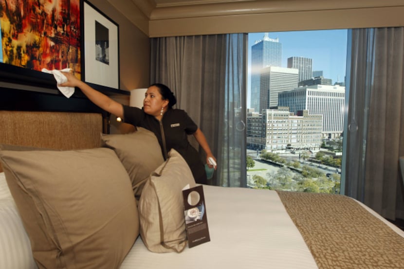 Housekeeper Maribel Perez tidies up a room at the Omni Hotel near the Dallas Convention...