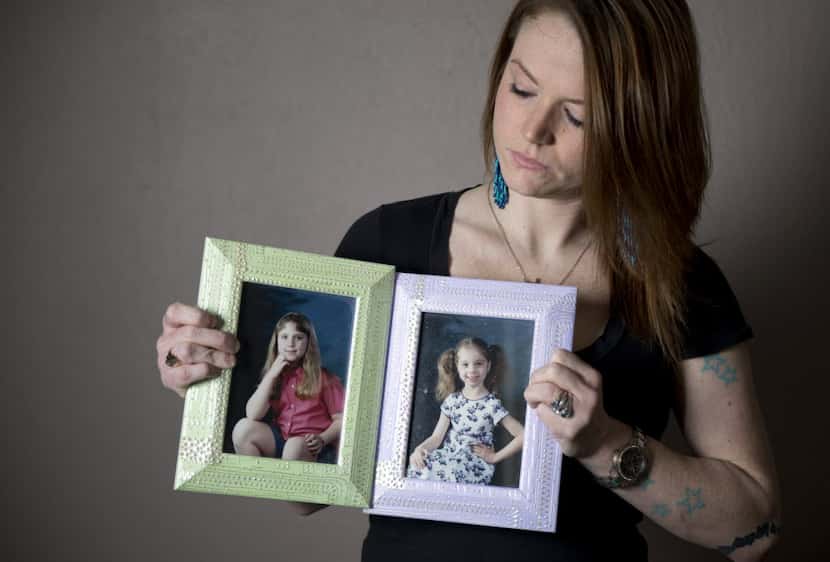 Christie Battaglia, daughter of convicted killer John Battaglia, holds up photos of her two...