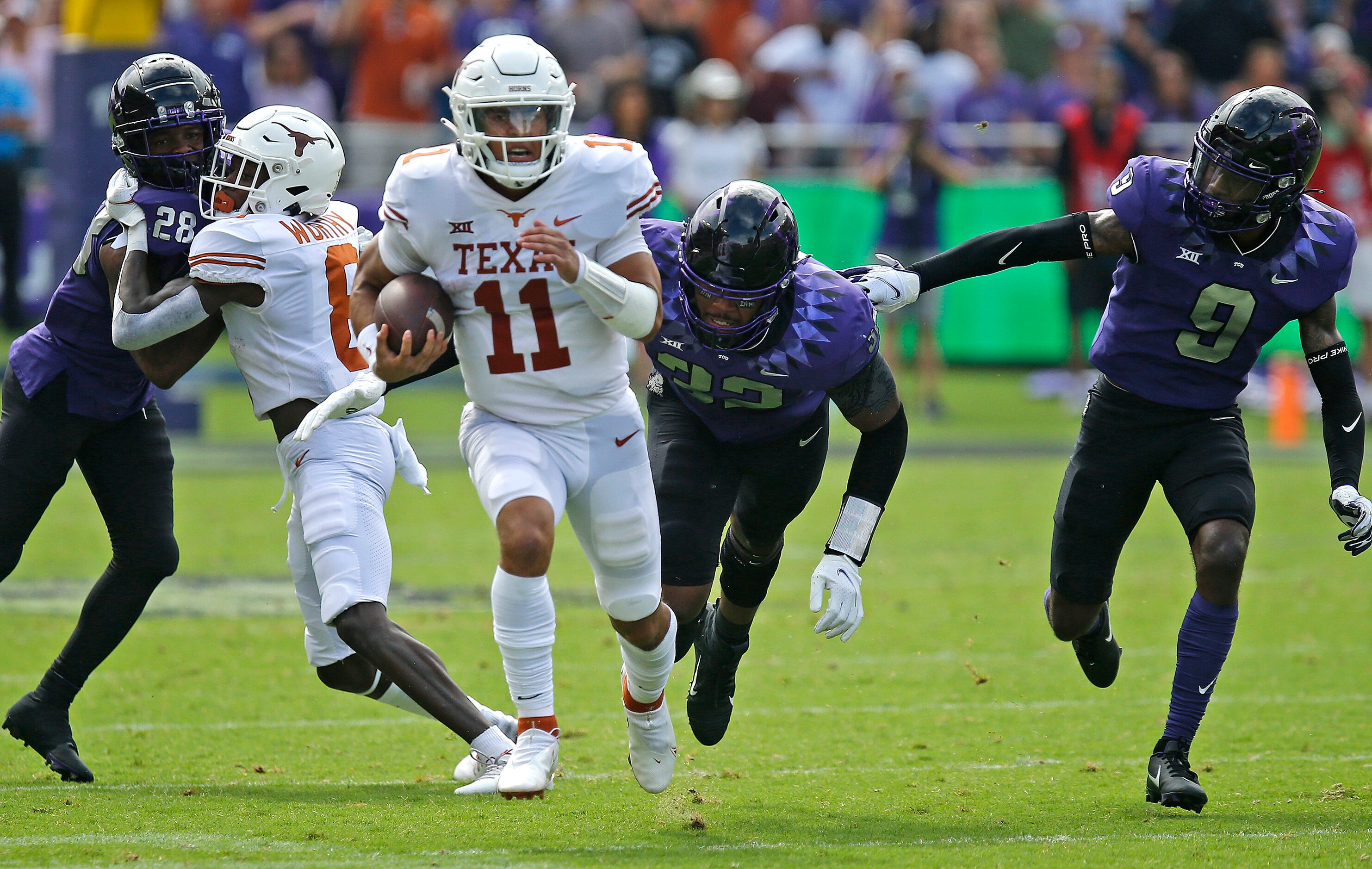 Texas Longhorns quarterback Casey Thompson (11) keeps the ball on a long gain during the...