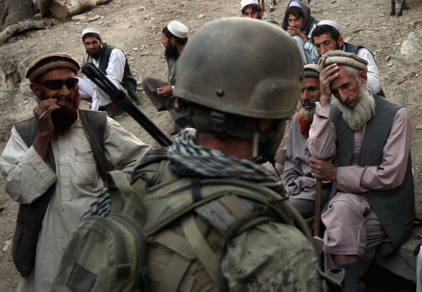  Village elders spoke with a U.S. Marine as Afghan forces search for weapons October 25,...