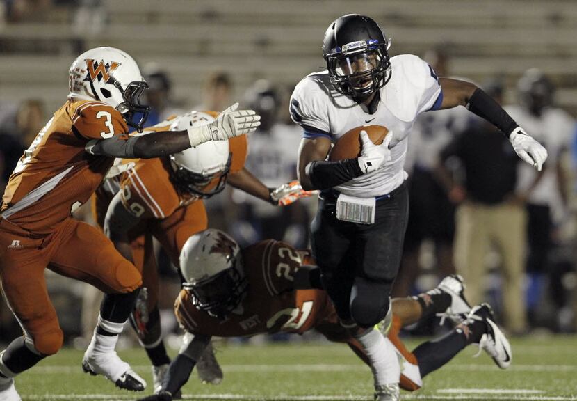 North Forney Falcons WR Armani Watts (5) moves the ball upfield against West Mesquite...