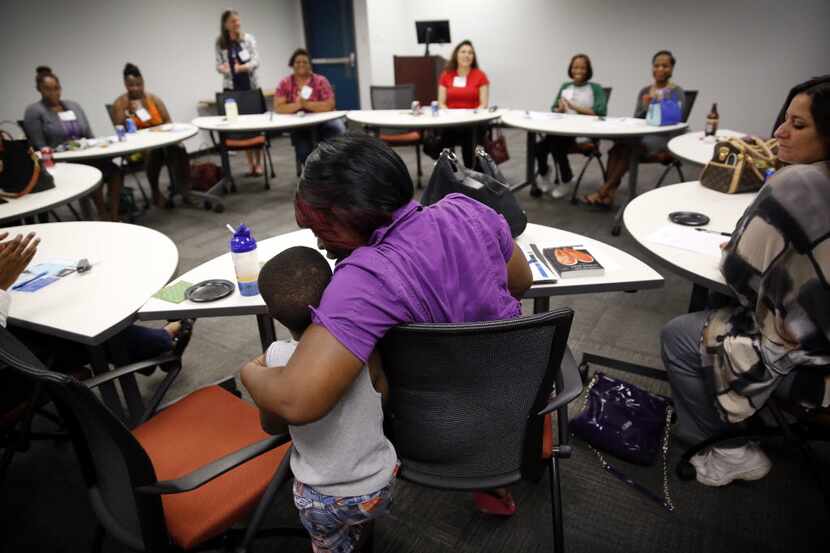 Antranette Canady hugs her 5-yr old grandson, Kwamane Dale during a Women's Independence...