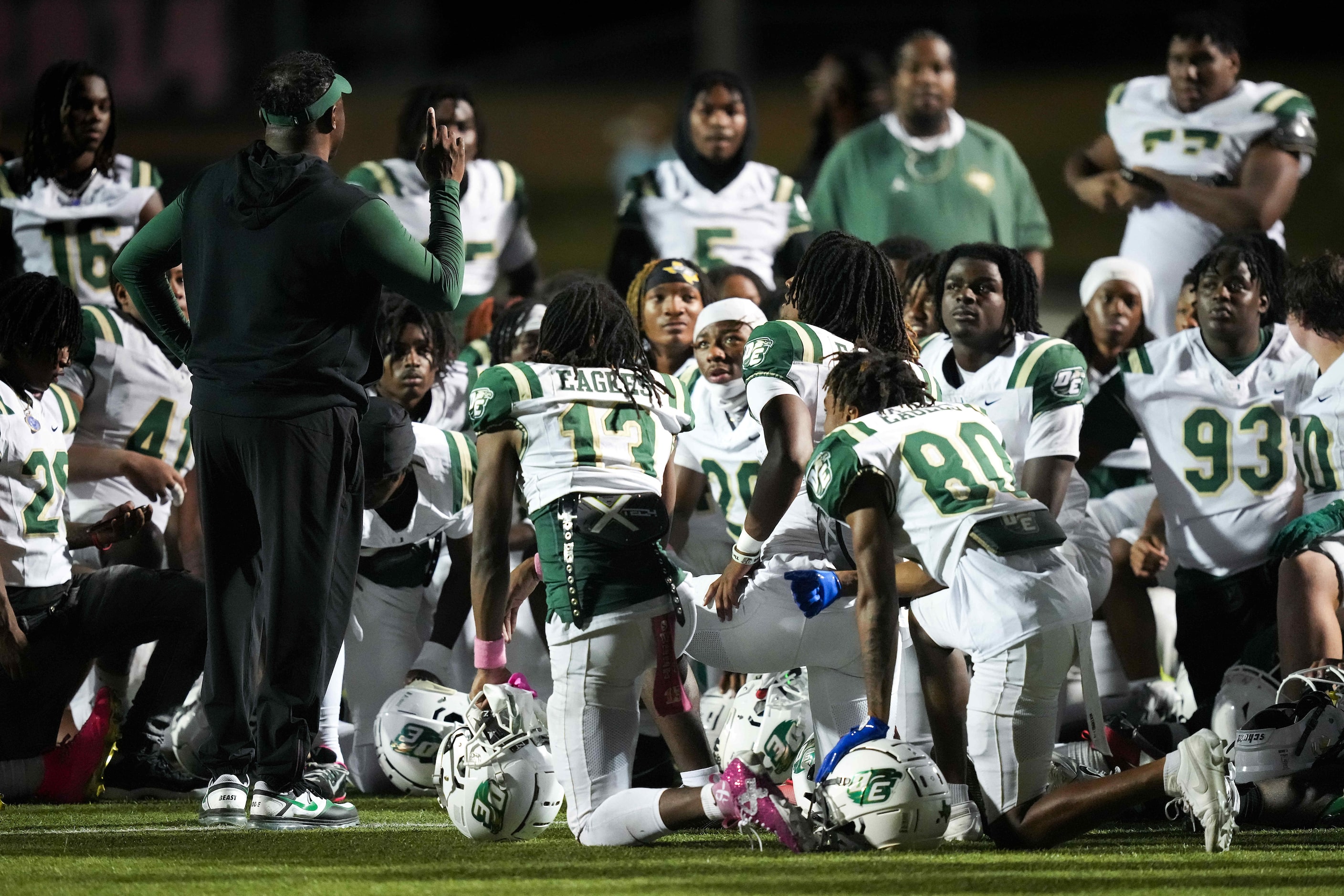 DeSoto head coach Claude Mathis addresses his team after a 63-24 victory over Cedar Hill in...