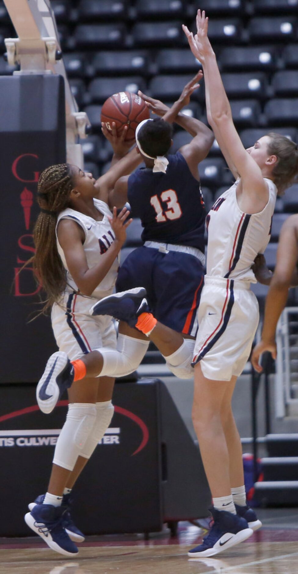 Sachse guard Jayla Brooks (13) takes a flying leap at shooting beyond the defense of Allen...