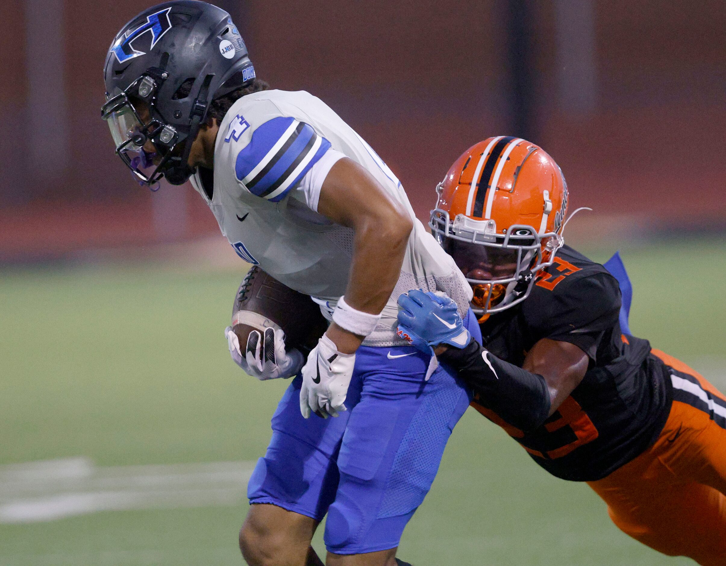 Hebron’s Sheldon Armour, left, is tackled by Lancaster’s Nathan Keeton (23) in the first...