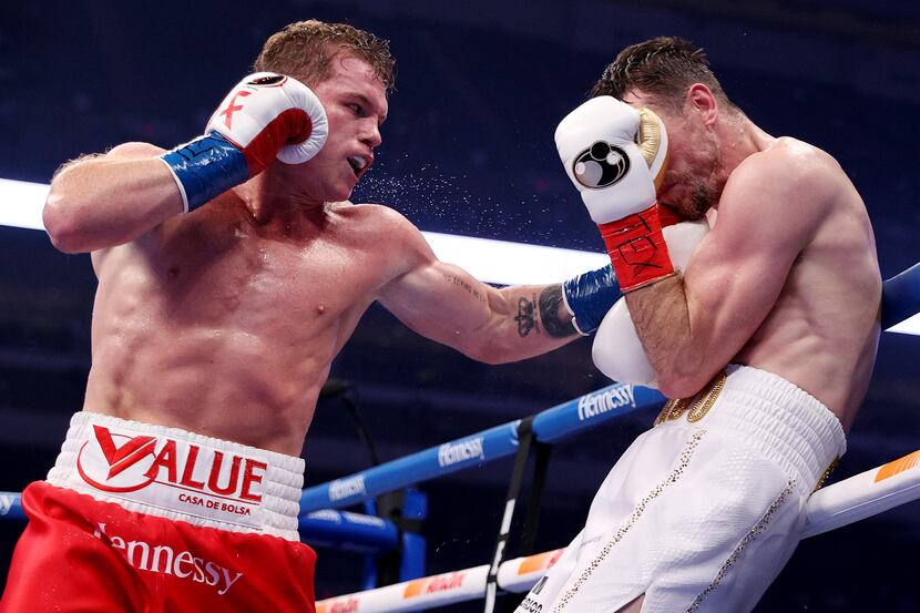 In this handout image provided by Matchroom, Canelo Alvarez punches Callum Smith during...